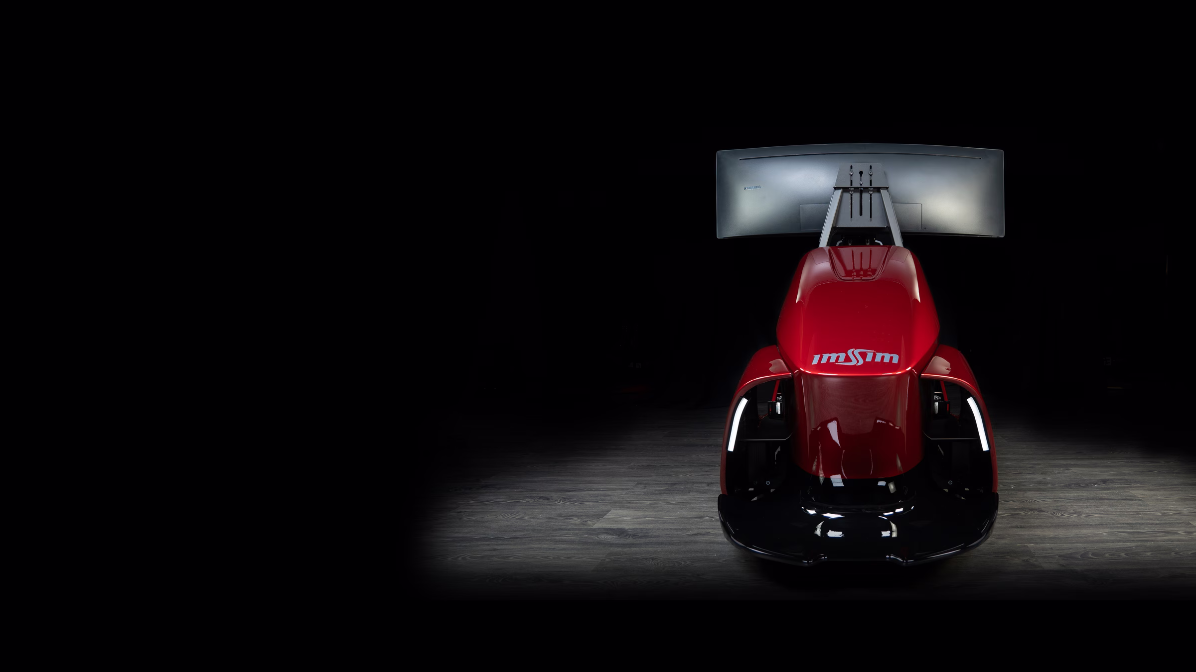 An ImSim GARRA simulator in red seen head on, lit in a dark studio.