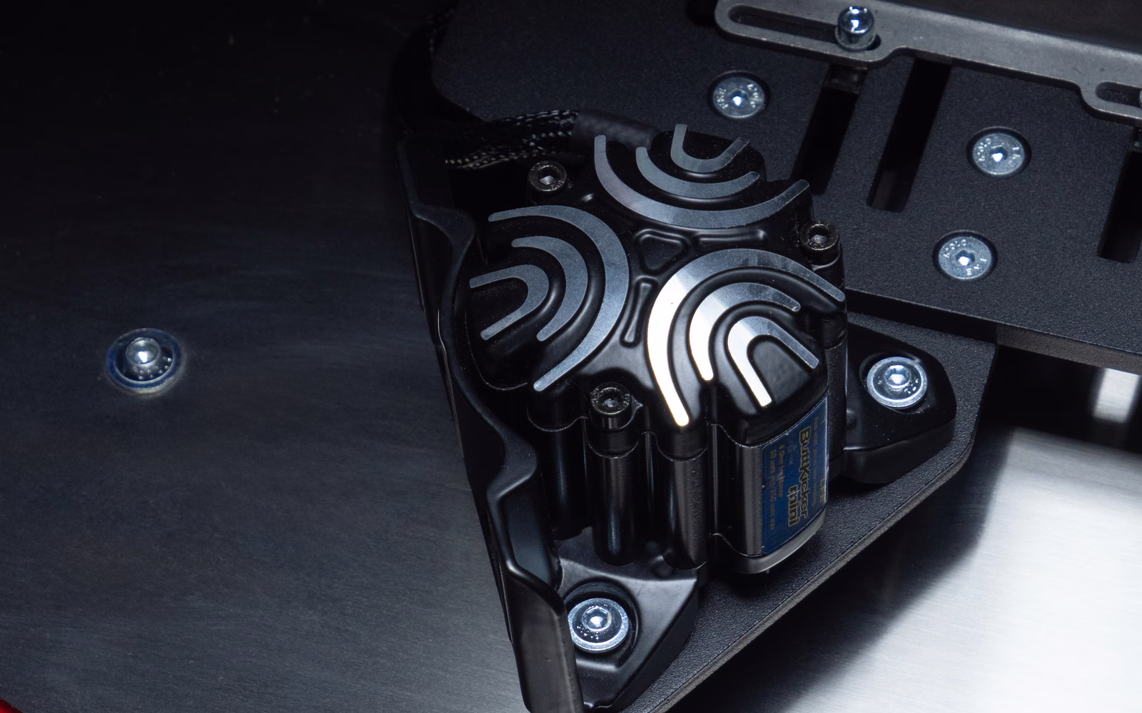 A tactile transducer, bolted under the plate.