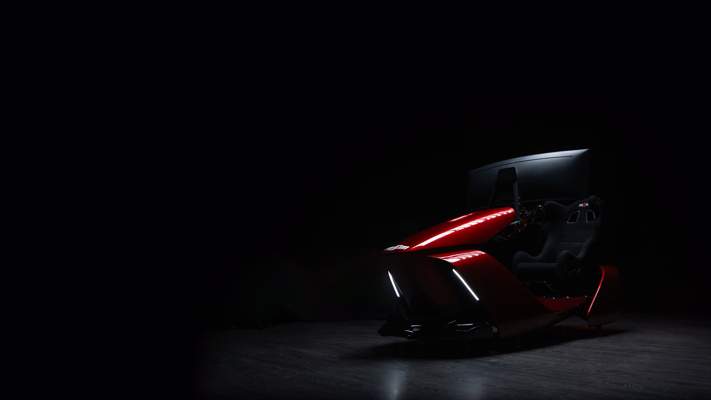 An ImSim GARRA simulator in red, seen from the front three quarter, lit in a dark studio.