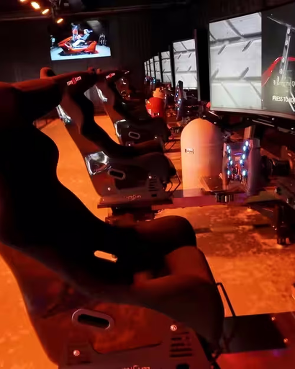 Guests racing on numbered simulators at Duinrell.
