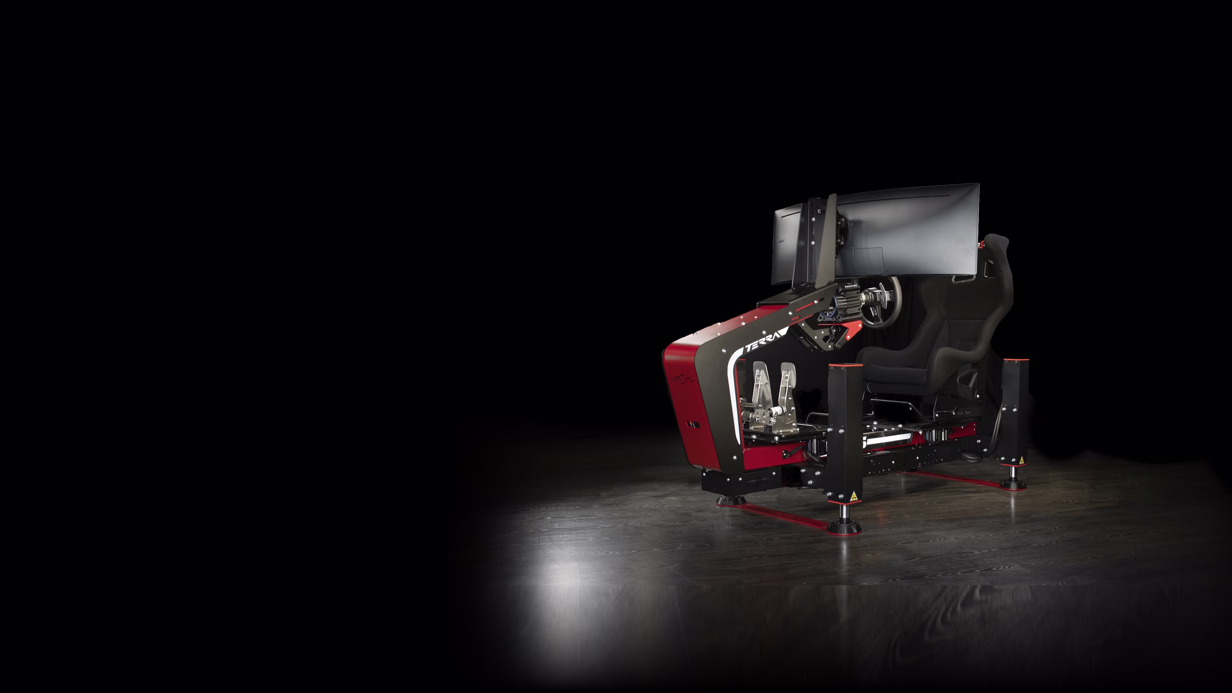 A TERRA simulator in red, on four actuators, lit in a dark studio.