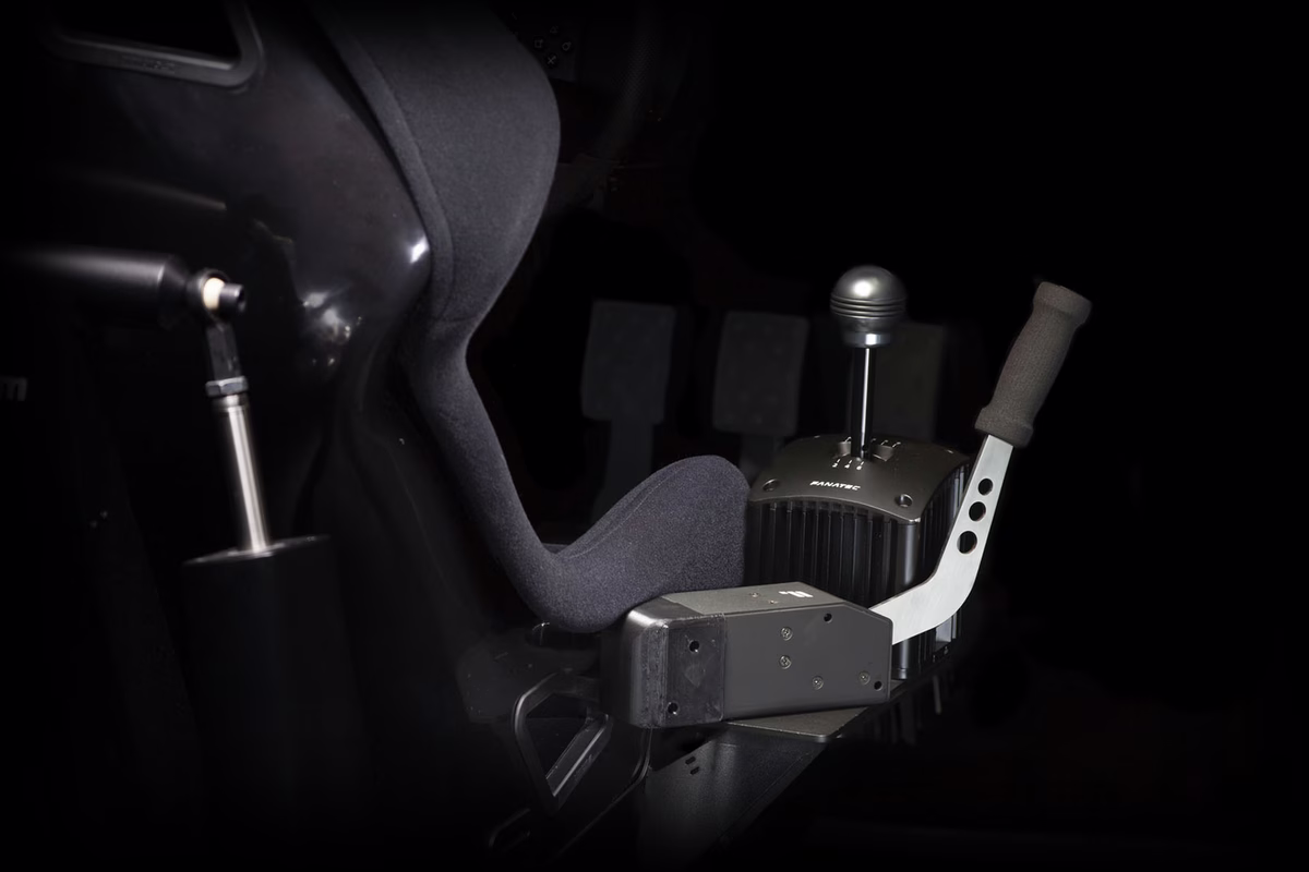A sequential shifter and a handbrake mounted beside the seat of an ImSim simulator.